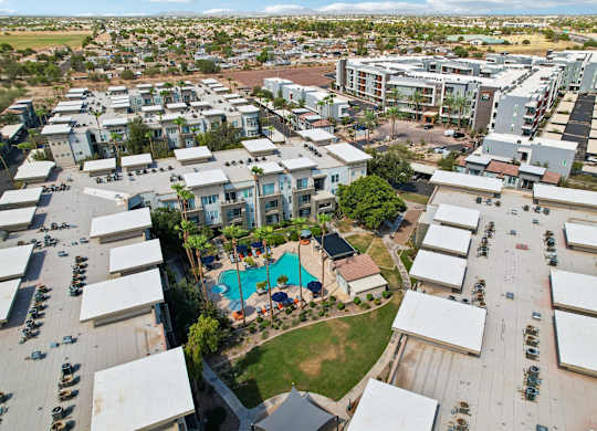 A bird's eye view of a residential area with a swimming pool.