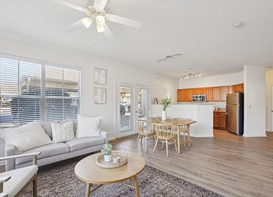 A living room with a grey couch and a wooden table.