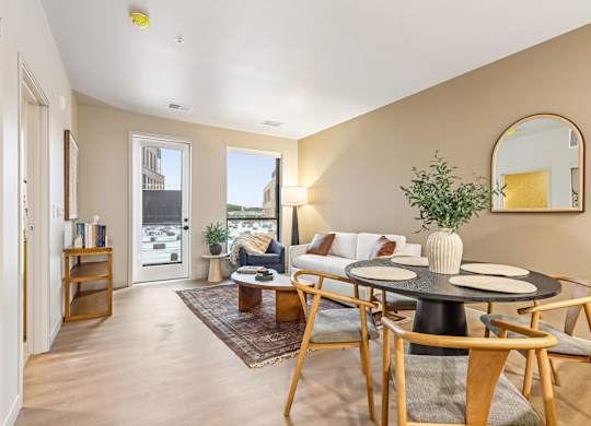 A living room with a round table and chairs.