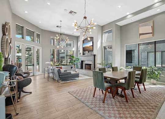 A modern living room with a dining table and chairs.