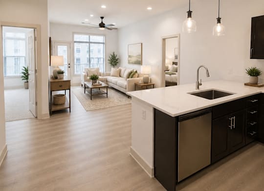 A modern kitchen with a large island and pendant lights.