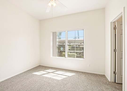 A room with a window and a door.