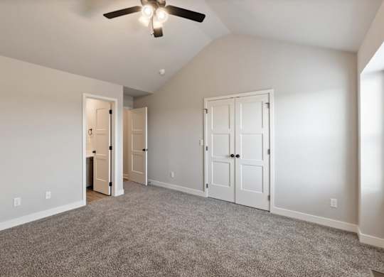 A room with a ceiling fan and two doors.