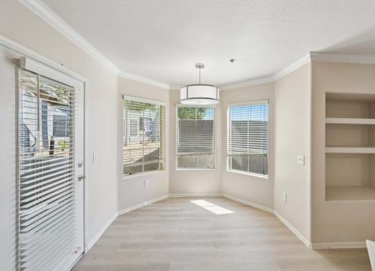 A spacious room with a sliding door and a built-in shelf.