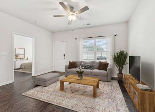 A living room with a grey couch, a wooden coffee table, and a flat screen TV.