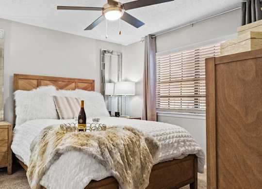 a bedroom with a bed and a ceiling fan