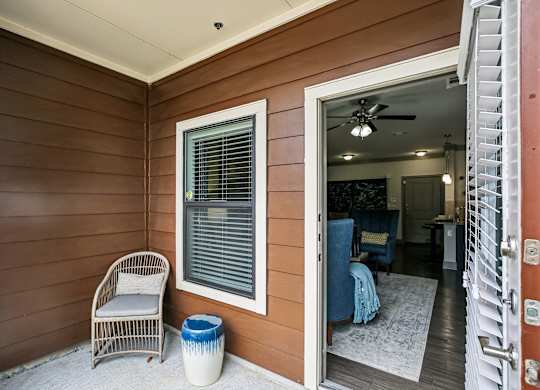 A room with a chair and a table is visible from the doorway.