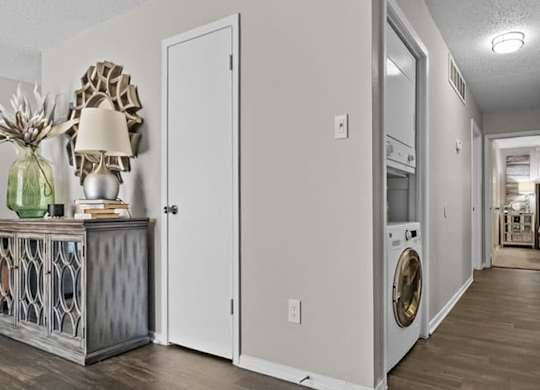 a white hallway with a washing machine and a dryer