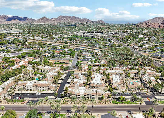 A view of a residential area with houses and palm trees.