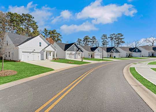 A row of houses with a street in between.