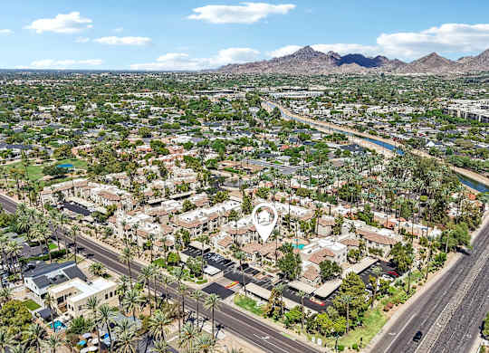 A bird's eye view of a residential area with a road running through it.