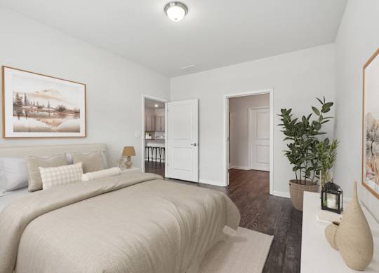 A bedroom with a large bed and a painting on the wall.