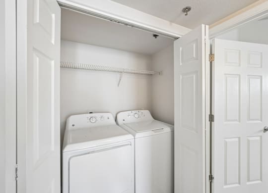 A white washing machine and dryer in a small laundry room.