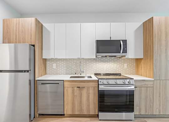 A modern kitchen with wooden cabinets and stainless steel appliances.