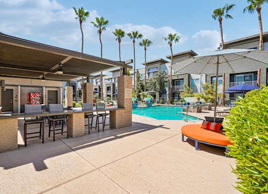 A poolside area with a bar and lounge chairs.