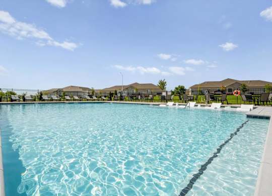 A large swimming pool with a blue tinted water.