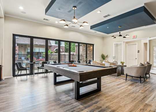 A room with a pool table and a chair.