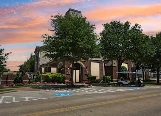 A parking lot with a golf cart and a building in the background.