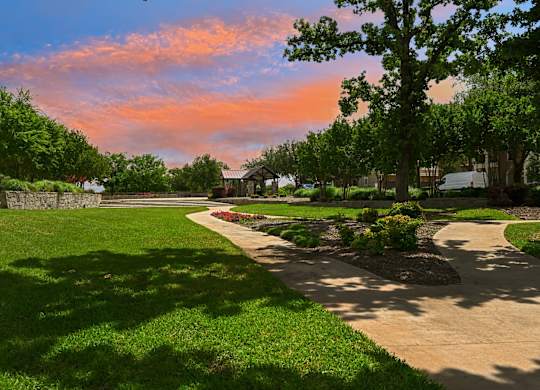 A beautiful park with a pathway and trees.