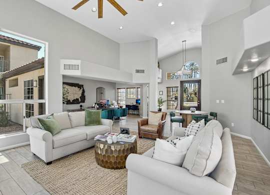 A modern living room with a white couch and a coffee table.