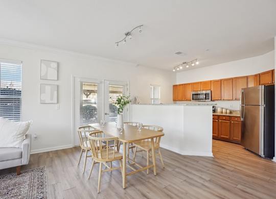 A modern kitchen with a dining table and chairs.