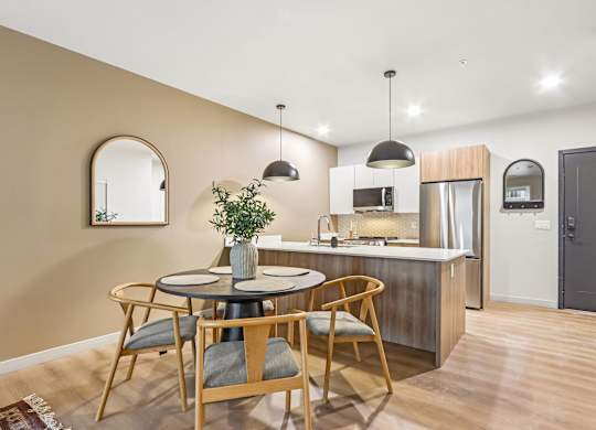 A kitchen with a round table and chairs.
