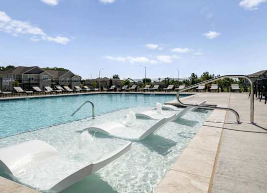 A large outdoor pool with a slide.