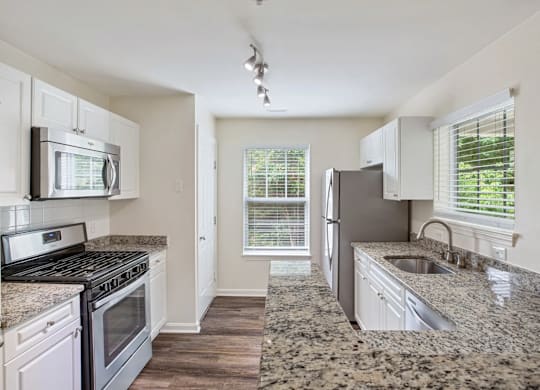 Kitchen with granite countertops and stainless steel appliances.