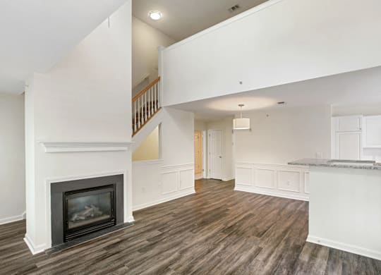 Open floorplan living room with a fireplace and high ceilings
