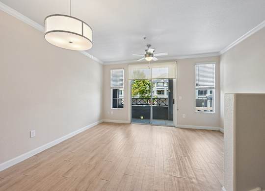 A room with a wooden floor and a ceiling fan.