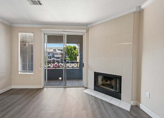 A living room with a fireplace and sliding glass doors.