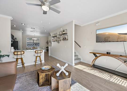A living room with a television and a bar area.