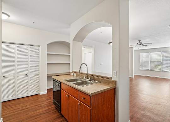 A kitchen with wooden cabinets and a sink.