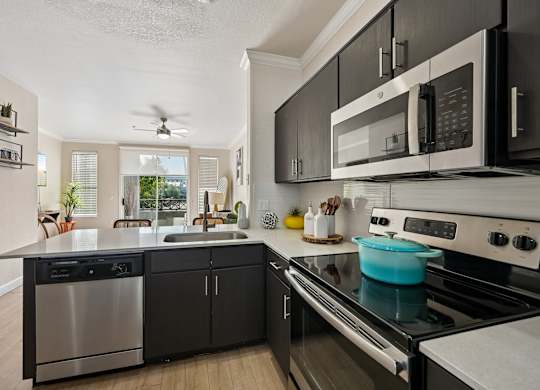 A modern kitchen with a stainless steel dishwasher and oven.