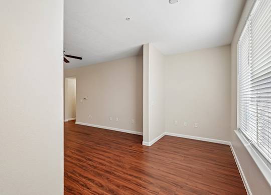 A room with wooden floors and white walls.