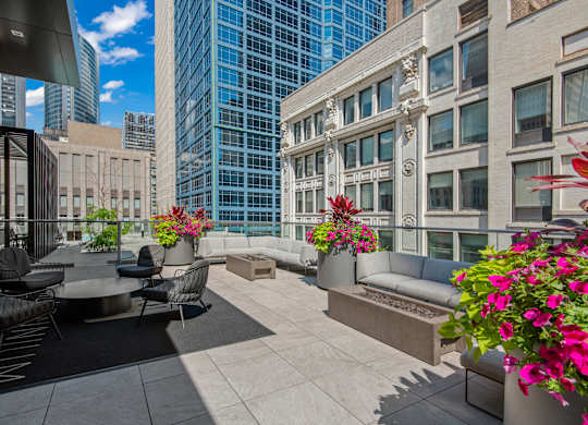 A patio with a table and chairs overlooking a city.