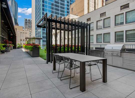 A table and chairs are set up on a patio.