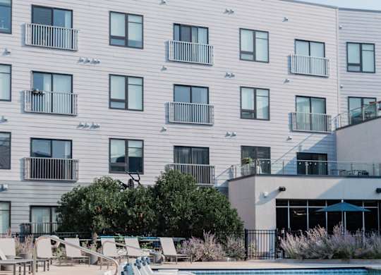A modern building with a pool in front.