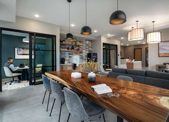 a dining room with a wooden table and chairs