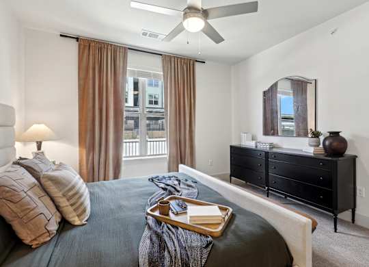 a bedroom with a bed and a ceiling fan