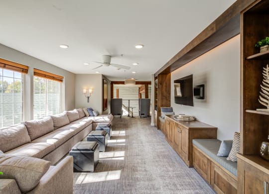 a large living room with couches and a television at Birchwood Apartment Homes in Maple Grove, MN