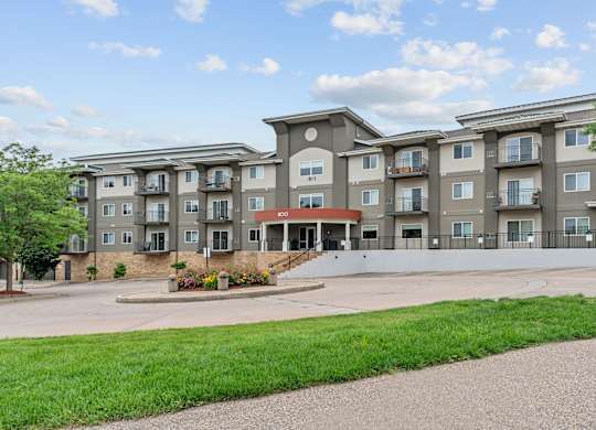 Apartment building with a green lawn in front.