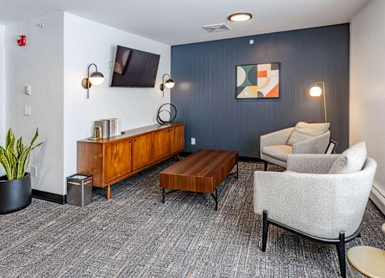 a living room with couches a coffee table and a tv