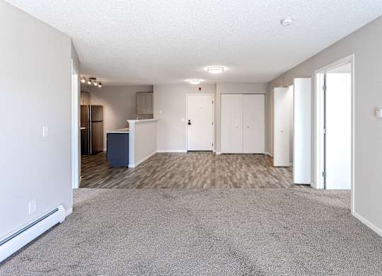 an empty living room and kitchen in a new home