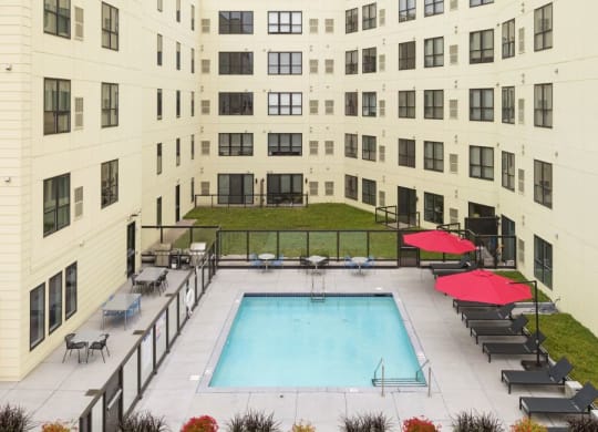 Outdoor pool and patio area with grills and fireplace C&E Living in St Paul, MN