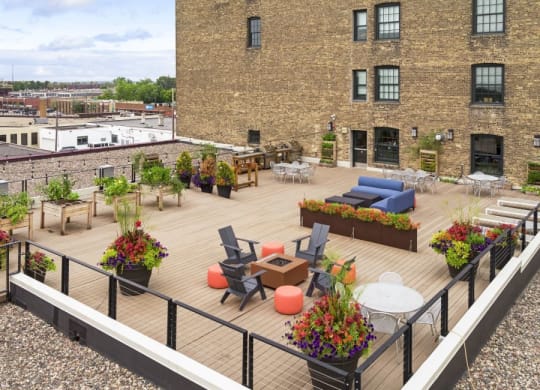 Rooftop terrace with lounging furniture, grills, and fireplaces C&E Living in St Paul, MN