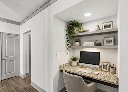 A home office with a desk, chair, and a computer.