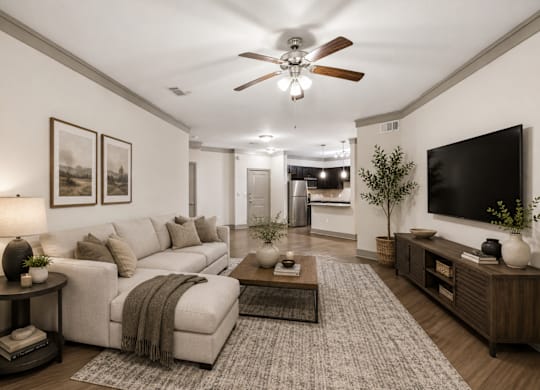 A living room with a white couch and a ceiling fan.