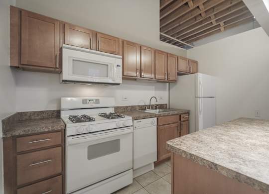 A kitchen with a white stove and brown cabinets.