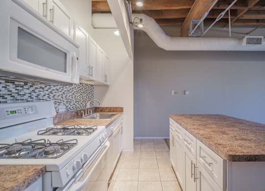 A kitchen with a white stove and a counter top.